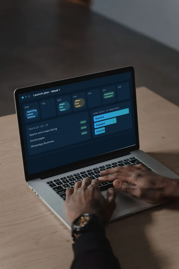 A laptop showing a launch content calendar with sample data.
